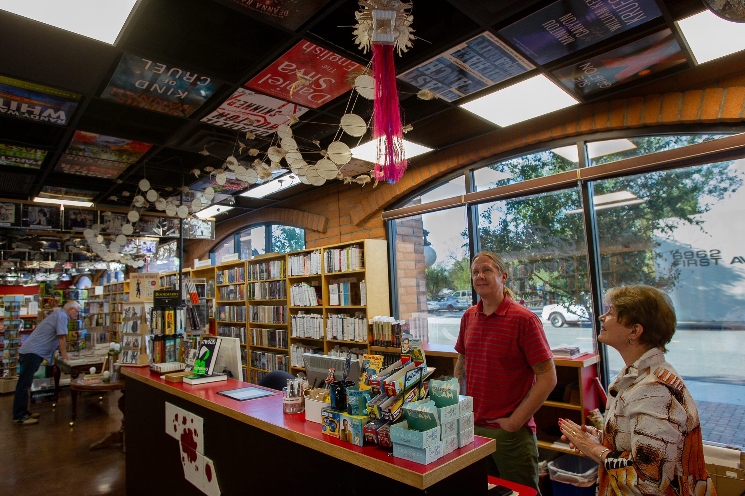 Posters of book covers, photos famous visitors and a large paper dragon are just some of the items decorating Poisoned Pen Bookstore, September 24, 2019.