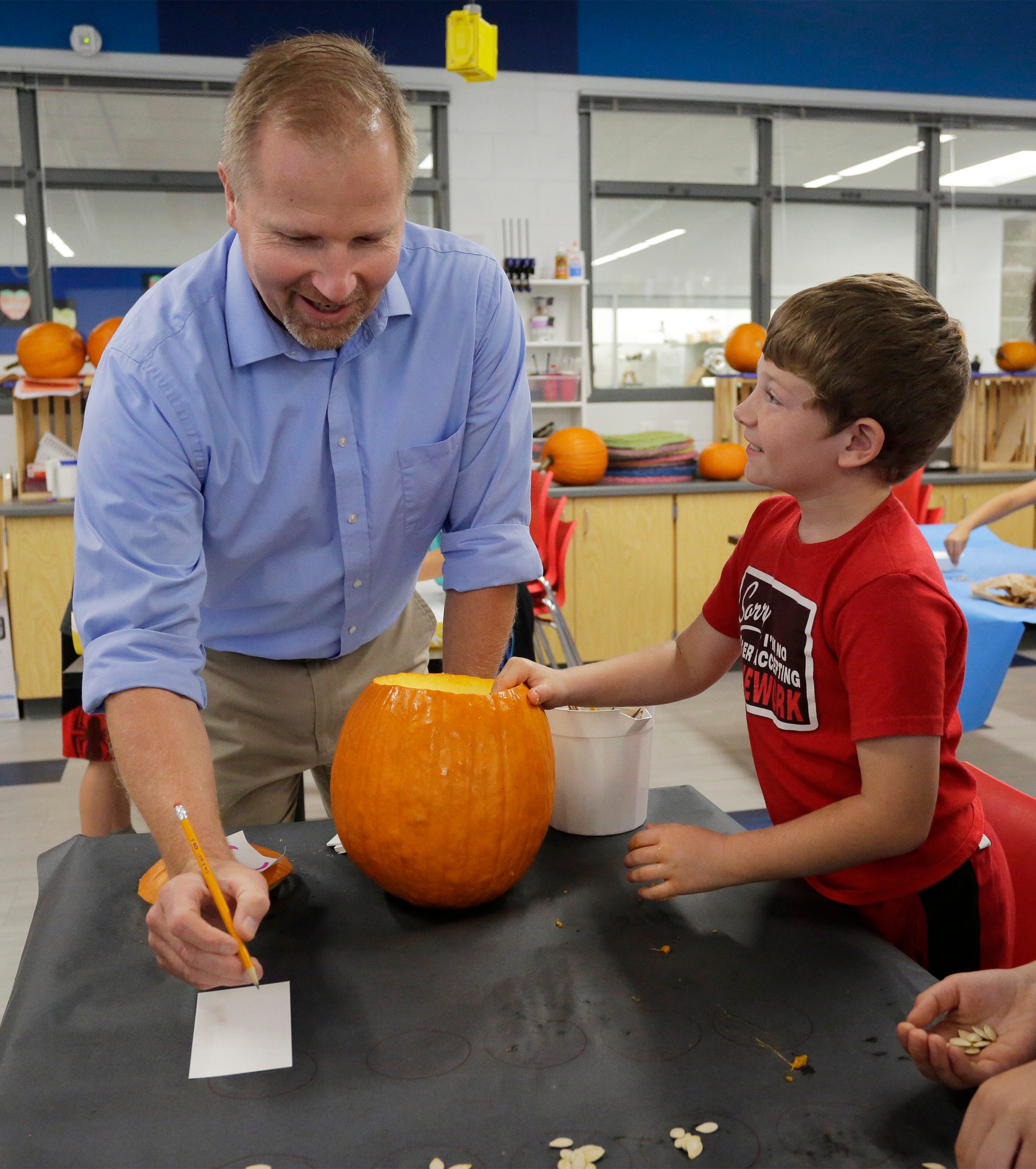 Oostburg Elementary science and social studies teacher Curt Bretall, left, explains a counting procedure for a pumpkin experiment to Jonathan Walvoord, Wednesday, Sept. 25, 2019, in Oostburg. The experiment is based on a question on the ACT Aspire exam administered to ninth and 10th graders across Wisconsin.