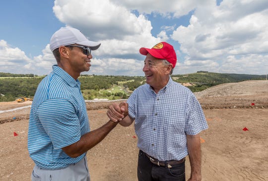 An undated publicity photo shows golf pro Tiger Woods with Bass Pro Shops founder Johnny Morris at Big Cedar Lodge near Branson, Missouri.