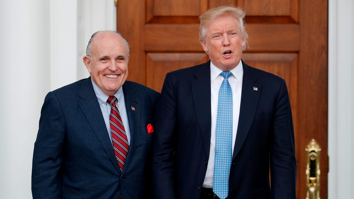 In this Nov. 20, 2016 photo, then-President-elect Donald Trump, right, and former New York Mayor Rudy Giuliani pose for photographs as Giuliani arrives at the Trump National Golf Club Bedminster clubhouse in Bedminster, N.J.