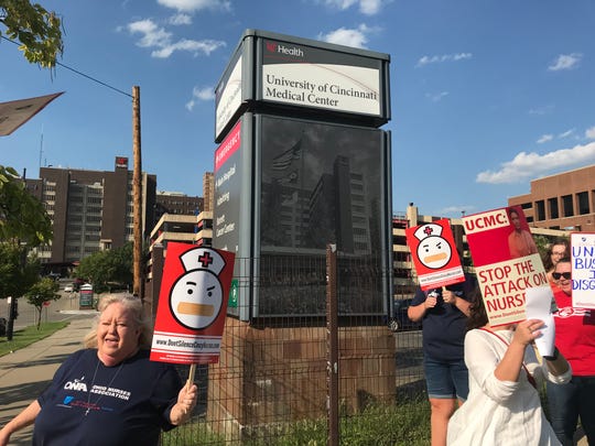Jennifer Donaldson, a registered nurse, walks an informational picket line Sept. 10 outside the University of Cincinnati Medical Center in Corryville.