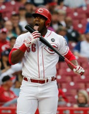 Cincinnati Reds right fielder Yasiel Puig (66) licks his bat after swinging for strike two in the second inning of the MLB National League game between the Cincinnati Reds and the Atlanta Braves at Great American Ball Park in downtown Cincinnati on Thursday, April 25, 2019.