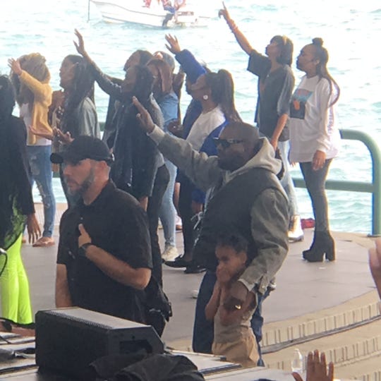 Kanye West, with daughter North West, pictured at his hip-hop revival on Detroit's Riverfront on Friday, Sept. 27.