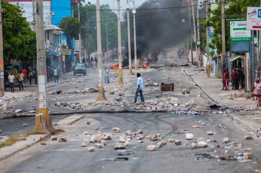 A man crosses a street full of barricades during protests in Port-au-Prince, Haiti, Sept. 17, 2019. Port-au-Prince and several provincial capitals of Haiti lived Tuesday the second consecutive day of protests against fuel shortages, a series of demonstrations in which there has already been registered one death.