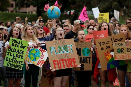 Climate protesters demonstrate Friday, Sept. 20, 2019, in Kansas City, Mo. Across the globe, people took to the streets Friday to demand that leaders tackle climate change in the run-up to a U.N. summit.
