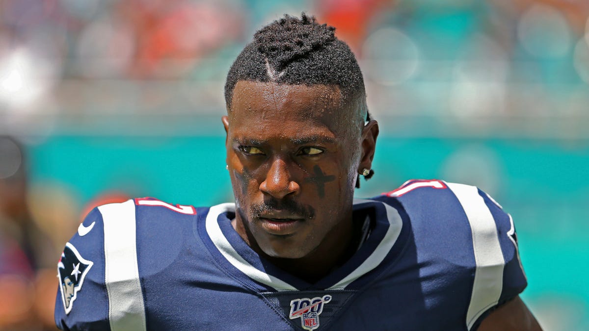 New England Patriots wide receiver Antonio Brown waits for the team's NFL football game against the Miami Dolphins to begin in Miami Gardens.