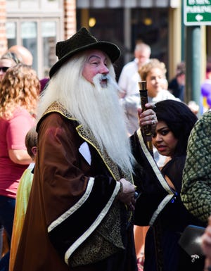 A man dressed as Dumbledore walks through West Beverley Street on Sept. 28 during Queen City Mischief and Magic.