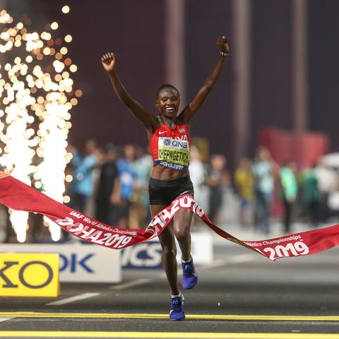 Ruth Chepngetich celebrates as she wins the women'