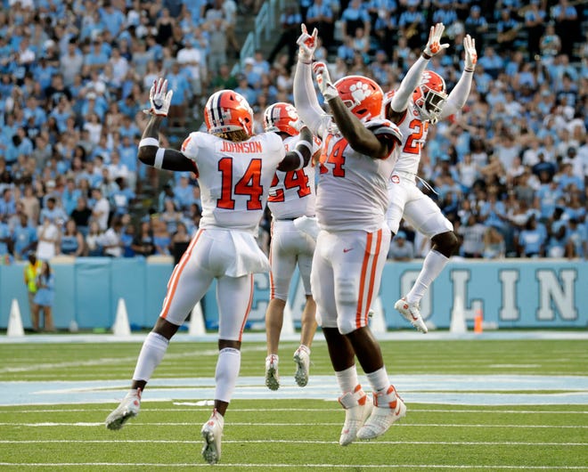 Clemson's Denzel Johnson (14), Nyles Pinckney (44), Nolan Turner (24) and Andrew Booth Jr. (23) celebrate after they stopped North Carolina on a two-point conversion in the closing moments on Saturday.