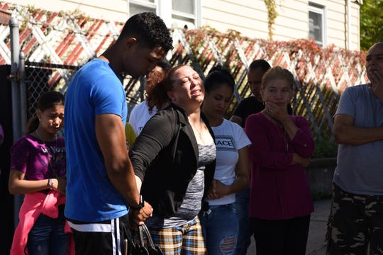 Friends and relatives arrive at the scene of an alleged murder-suicide on E 16th St. in Paterson near Lyon St. on September 29, 2019.