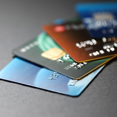 stack of multicolored credit cards on black backgr