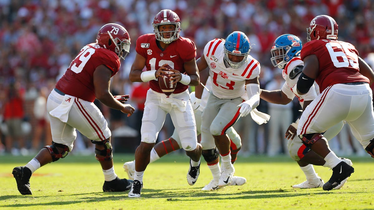 Alabama quarterback Tua Tagovailoa escapes the pocket as he looks to pass against Mississippi.