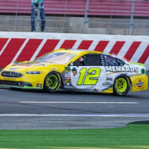 Ryan Blaney (12) speeds past Jimmie Johnson (48) a