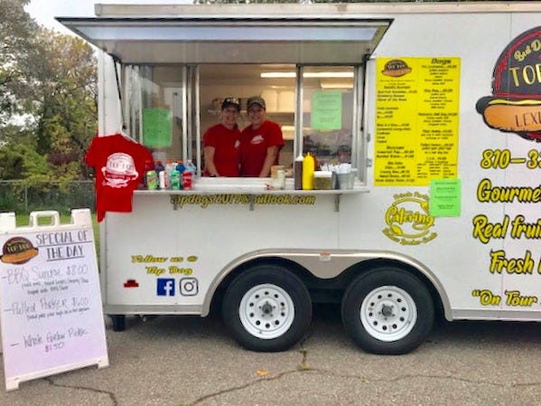 Debbie Strausser and her daughter Taryn Strausser run their food truck Top Dog at a Detroit event.