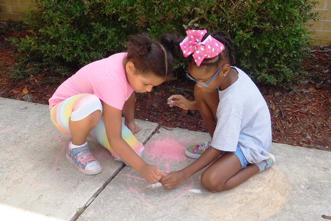 Students were encouraged to practice peaceful collaboration in the creation of their sidewalk artworks.