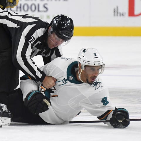 Linesman Kiel Murchison lands on Sharks forward Ev