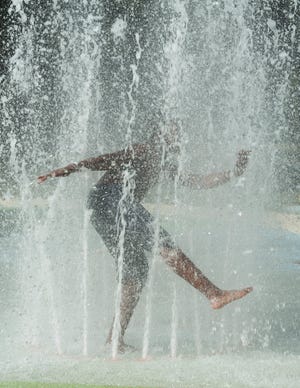 Tyler Ross, 9, of Jackson, cools off in the water of the Jackson Zoo Splash Pad