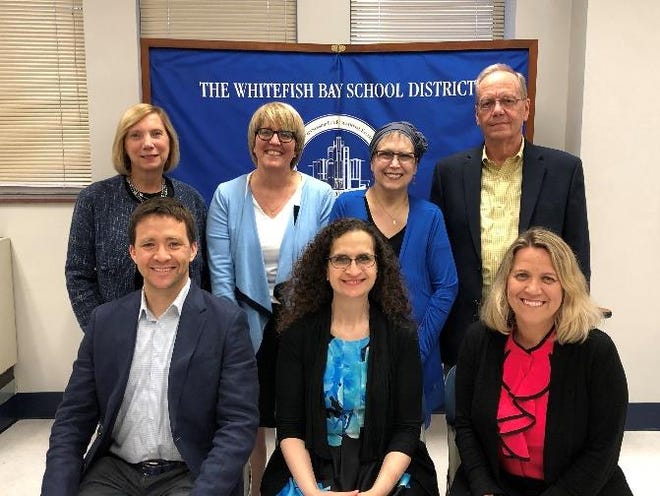 Kristin Yunker (third from left, back row) poses with fellow Whitefish Bay School Board members. Yunker died Sept. 24 of complications from breast cancer. Pictured are (from left, front row) board Treasurer W. Brett Christiansen, President Sandy Saltzstein, Vice President, Clerk Kristin Bencik-Boudreau, (back row) board members Pam Woodard, Anne Kearney, Yunker and Doug Armstrong.