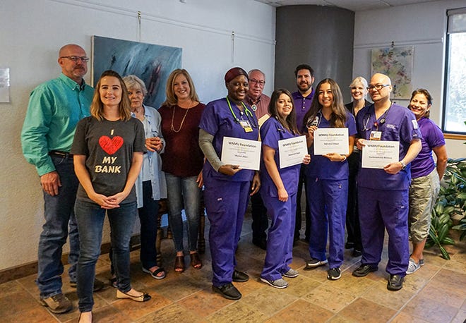 The Martin family presents scholarships to four Western New Mexico University nursing students. Back row, from left: Michael Martin, Marie Martin, Sue Braune, Robert Martin, George Turner of the WNMU Foundation, Kim Peltrovic and Soccorro Rico of the WNMU School of Nursing. Front row, from left: Cari Lemon of Western Bank; and 2019-20 scholarship recipients Marian Allen, Savannah Parga, Adrianna Odogui and Damien Antonio Whitlock.
