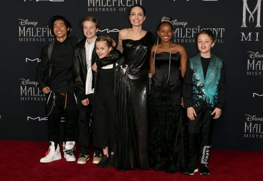 Angelina Jolie, third right, and her children, from left, Maddox Jolie-Pitt, Shiloh Jolie-Pitt, Vivienne Jolie-Pitt, Zahara Jolie-Pitt and Knox Jolie-Pitt arrive at the world premiere of "Maleficent: Mistress of Evil" on Monday, Sept. 30, 2019, at the El Capitan Theatre in Los Angeles. (Photo by Willy Sanjuan/Invision/AP) ORG XMIT: CAPM127