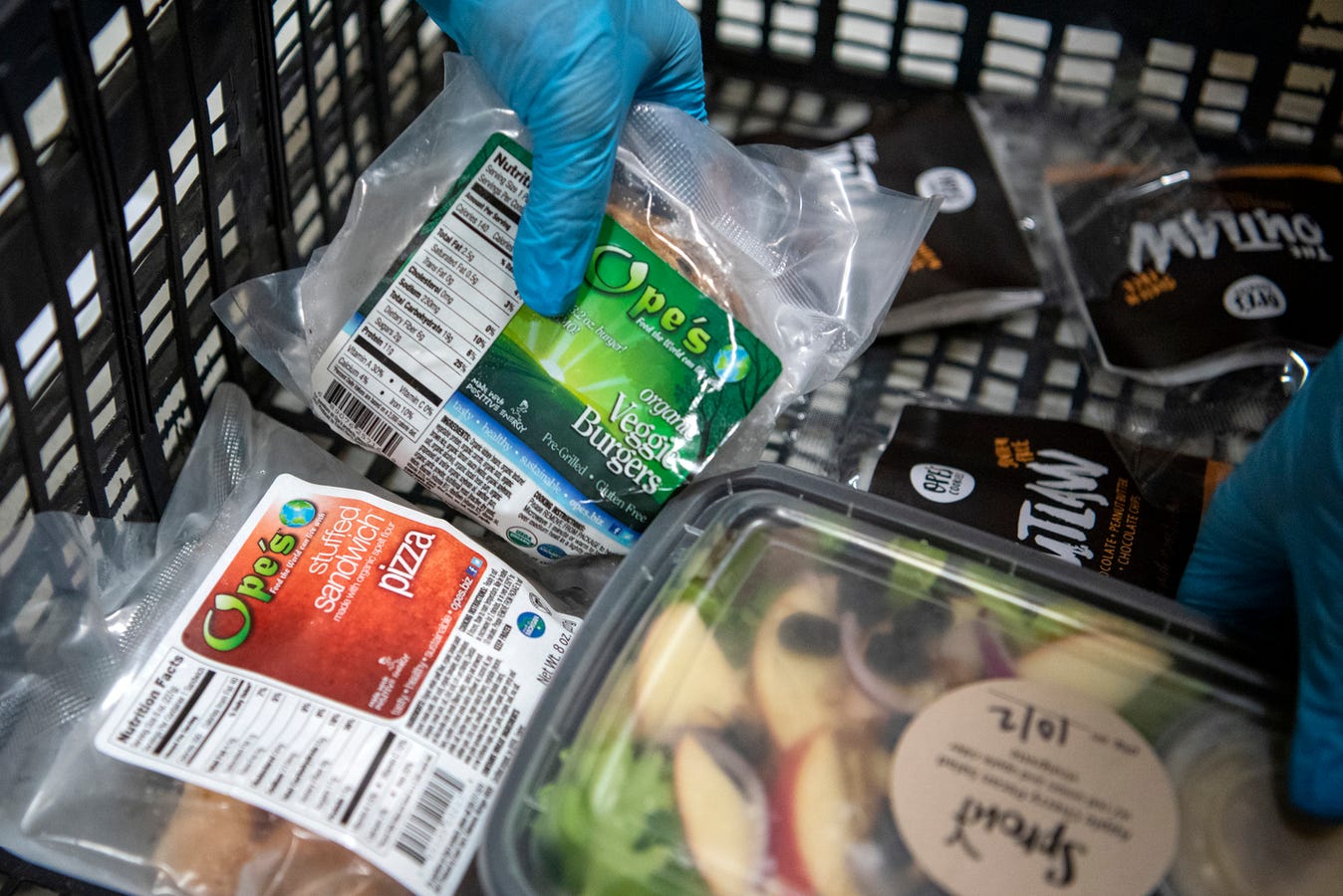 Volunteers assemble grocery orders, some with meat alternatives, on Wednesday, Oct. 2, 2019 at Sprout in Battle Creek, Mich. The nonprofit Sprout sells customized grocery orders of locally sourced products.