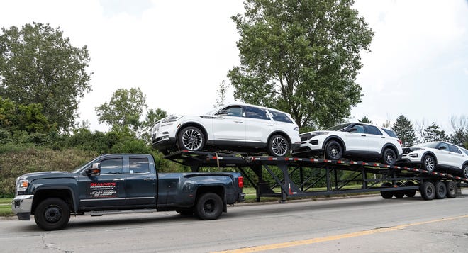 Two Ford Explorers and one Lincoln Aviator are seen on a car hauler on Gibraltar Road near Ford's Flat Rock Assembly Plant in Flat Rock, Wednesday, September 11, 2019.