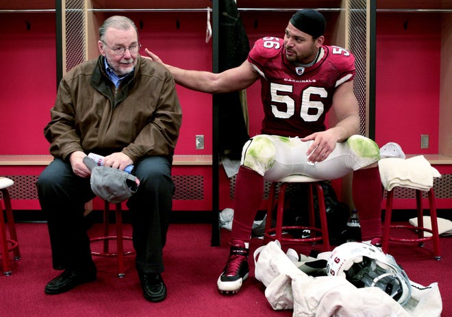 Arizona Cardinals owner Bill Bidwill and Chike Okeafor sit in the locker room after winning NFC West by defeating St. Louis Rams at University of Phoenix Stadium in Glendale in 2008.