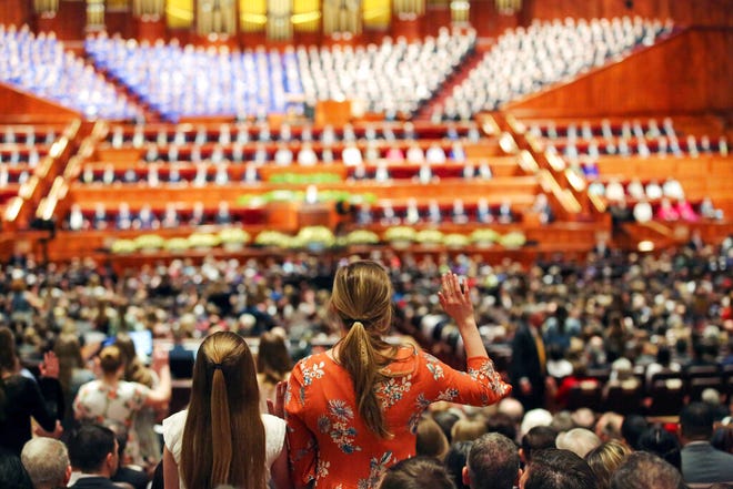 FILE - In this March 31, 2018, file photo, people participate in a solemn assembly during the start of a twice-annual conference of The Church of Jesus Christ of Latter-day Saints, in Salt Lake City. The Church of Jesus Christ of Latter-day Saints will allow women to be official "witnesses" at two key ceremonies where they were previously only allowed to observe in the latest small step toward breaking down rigid gender roles in the religion. Church President Russell M. Nelson said in a news release Wednesday, Oct. 2, 2019, that the policy change allows women to serve as witnesses at baptisms for the living and dead and at a ceremony inside church temples for married couples called a "sealing," which the faith believes unites the couple for eternity. (AP Photo/Rick Bowmer, File)