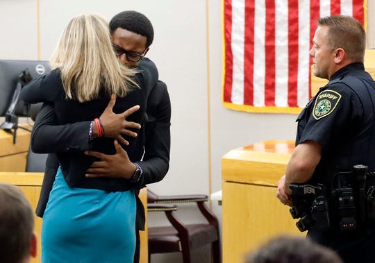 Botham Jean's younger brother Brandt hugs convicted murderer and former Dallas Police Officer Amber Guyger after she was sentenced to 10 years in jail on Wednesday.