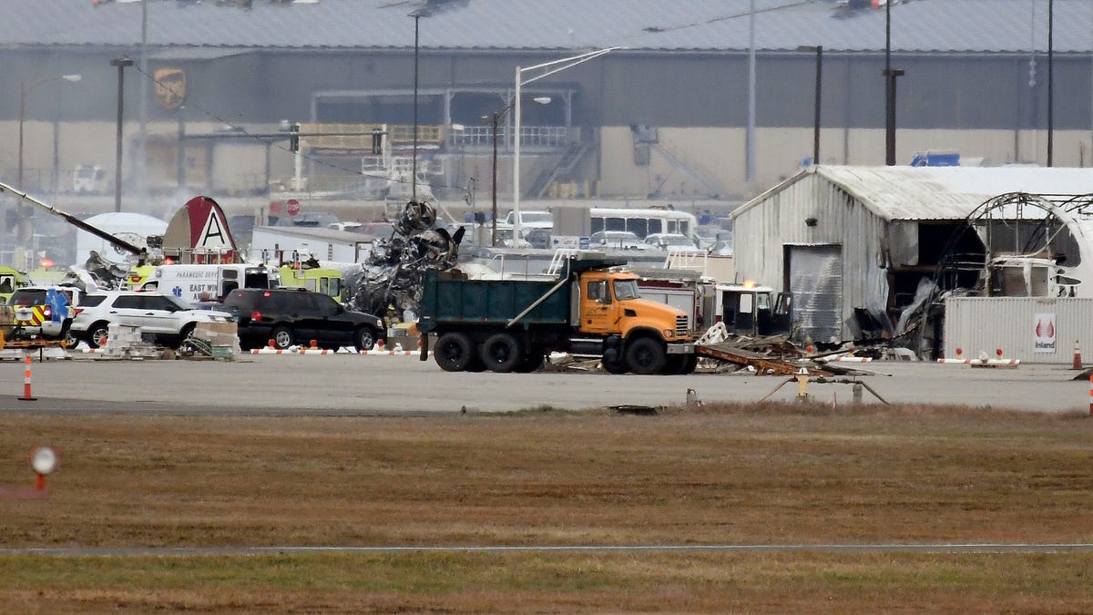 A fire-and-rescue operation is underway where World War II-era bomber plane crashed at Bradley International Airport in Windsor Locks, Conn., Oct. 2, 2019. A fire with black smoke rose from near the airport as emergency crews responded. The airport said in a message on Twitter that it has closed.