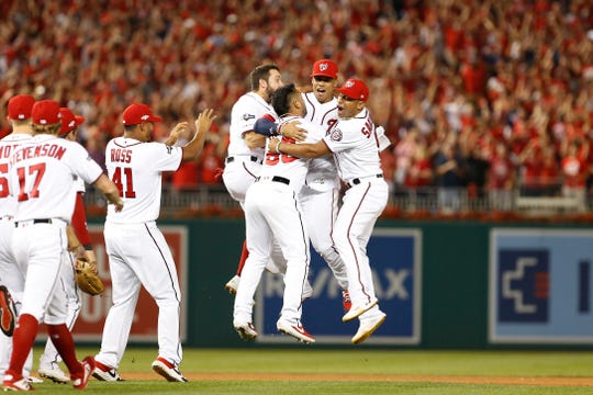 Nationals players celebrate the final out.