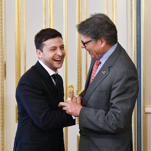 President of Ukraine Volodymyr Zelensky shakes han