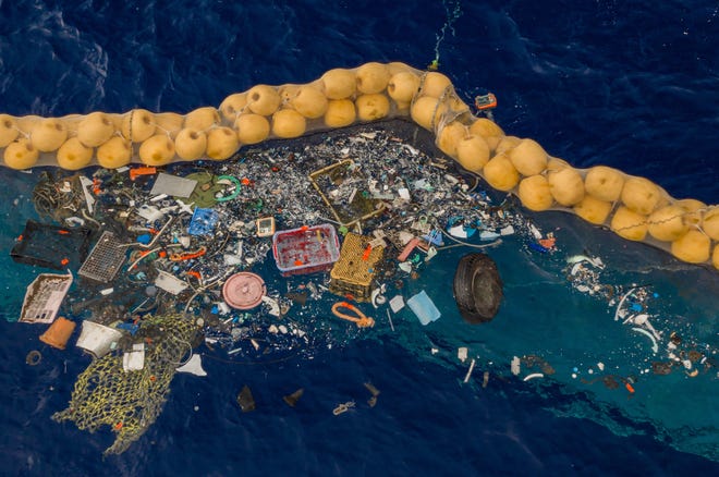 A handout photo made available by The Ocean Cleanup shows the company's ocean cleanup prototype System 001/B capturing plastic debris in the Great Pacific Garbage Patch, in the Pacific Ocean, on September 30, 2019. The self-contained system uses natural currents of the sea to passively collect plastic debris in an effort to reduce waste in the ocean.