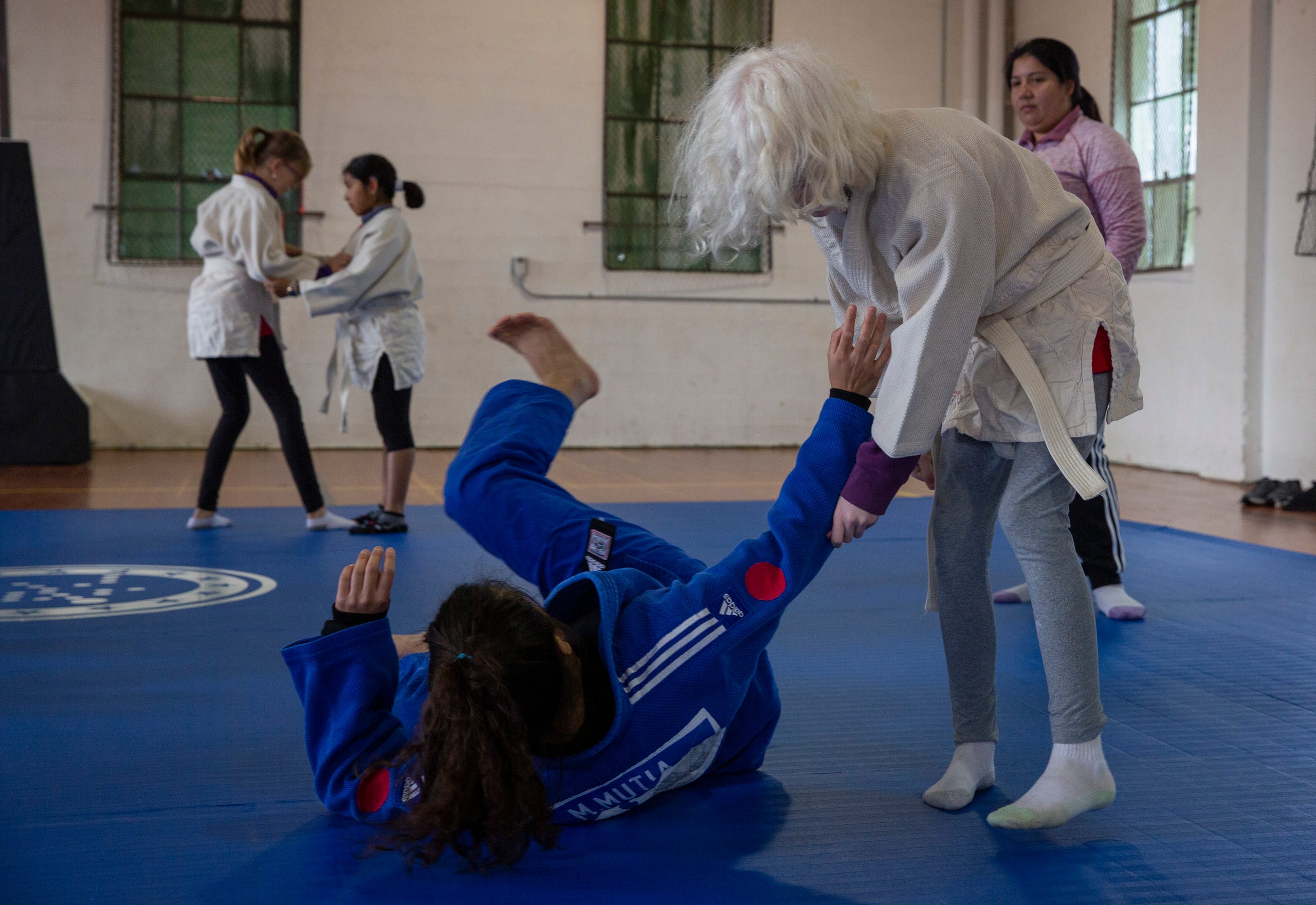 Fifth-grader Emily Underwood practices a move on Judo World Champion, Liana Mutia, at the Oregon School for the Deaf in Salem, Oct. 4, 2019. NWABA, the Northwest Association for Blind Athletes, hosted a "Paralympic experience" for students with visual impairments in the state. After the Oregon School for the Blind closed in 2009, many visually impaired students and their families lost access to state-funded resources, like sports programs. The BVIS (Blind Visually Impaired Student) Fund gives programs like NWABA funds to enhance the lives of low vision/blind children across the state.