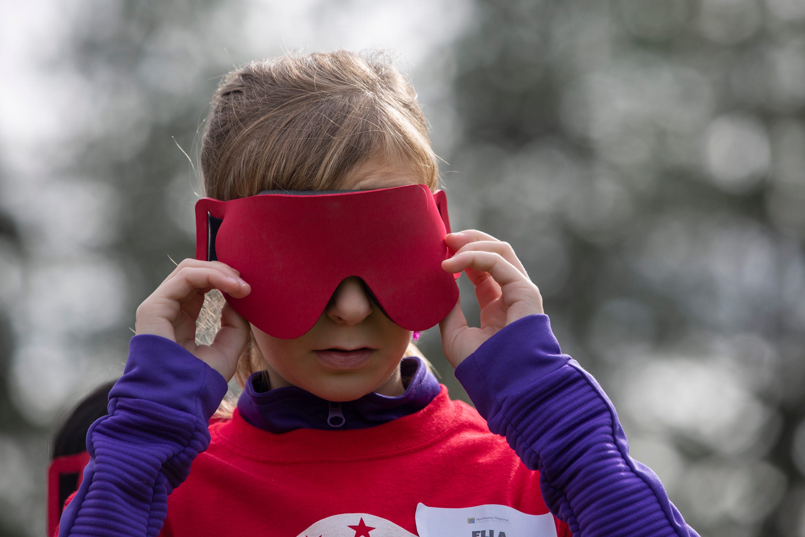 Ella Shrout, a 7th grader, puts on the blindfold required to play beep kickball at the Oregon School for the Deaf in Salem, Oct. 4, 2019. NWABA, the Northwest Association for Blind Athletes, hosted a "Paralympic experience" for students with visual impairments in the state. After the Oregon School for the Blind closed in 2009, many visually impaired students and their families lost access to state-funded resources, like sports programs. The BVIS (Blind Visually Impaired Student) Fund gives programs like NWABA funds to enhance the lives of low vision/blind children across the state.