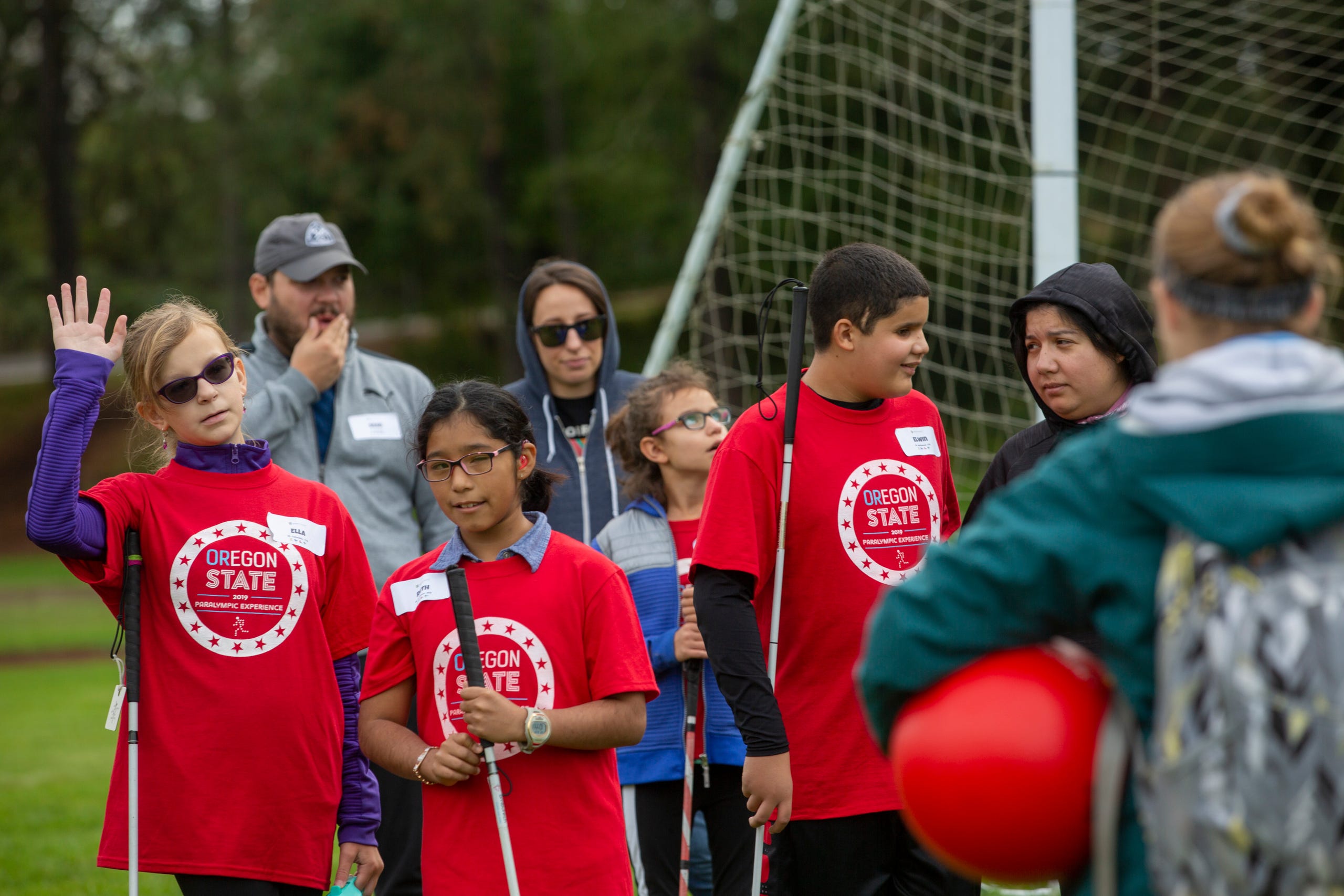 Ella Shrout, a 7th grader, raises her hand to answer a question about beep kickball at the Oregon School for the Deaf in Salem, Oct. 4, 2019. NWABA, the Northwest Association for Blind Athletes, hosted a "Paralympic experience" for students with visual impairments in the state. After the Oregon School for the Blind closed in 2009, many visually impaired students and their families lost access to state-funded resources, like sports programs. The BVIS (Blind Visually Impaired Student) Fund gives programs like NWABA funds to enhance the lives of low vision/blind children across the state.