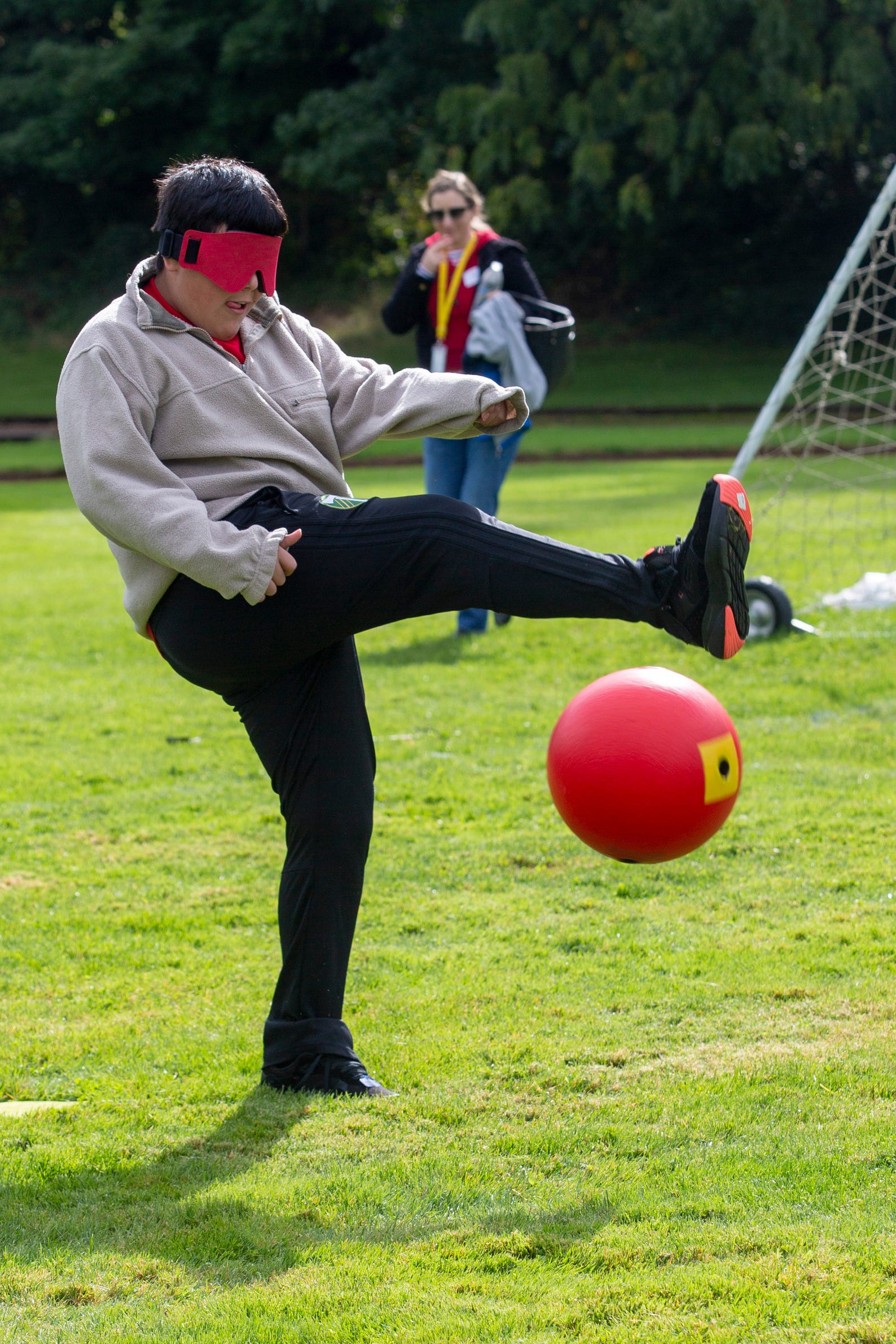 Luis Alvarez-Castaneda, a 6th grader, takes a mighty kick during beep kickball at the Oregon School for the Deaf in Salem, Oct. 4, 2019. NWABA, the Northwest Association for Blind Athletes, hosted a "Paralympic experience" for students with visual impairments in the state. After the Oregon School for the Blind closed in 2009, many visually impaired students and their families lost access to state-funded resources, like sports programs. The BVIS (Blind Visually Impaired Student) Fund gives programs like NWABA funds to enhance the lives of low vision/blind children across the state.