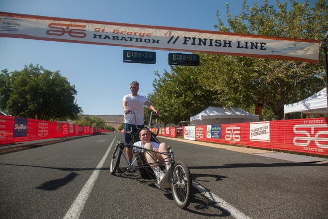 Brian Connolly rides in his marathon trike for the first time while his brother, Dan Connolly, pushes Friday, Oct. 4, 2019.