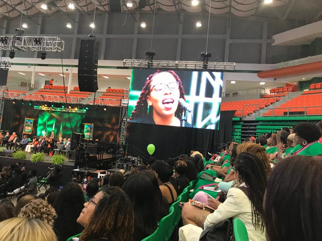 A singer with the FAMU Concert Choir Ensemble is featured on the large screen while singing at Friday's Homecoming Convocation. Oct. 4, 2019