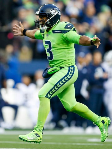 Seattle Seahawks quarterback Russell Wilson (3) celebrates after throwing a touchdown pass against the Los Angeles Rams during the second quarter at CenturyLink Field.
