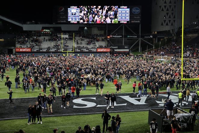 Cincinnati Bearcats fans storm the field after the 27-24 win against the UCF Knights, Friday, Oct. 4, 2019, at Nippert Stadium in Cincinnati. 