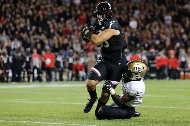 Cincinnati Bearcats tight end Josiah Deguara (83) eyes the end zone on a catch in the second quarter of a college football game against the UCF Knights, Friday, Oct. 4, 2019, at Nippert Stadium in Cincinnati. 