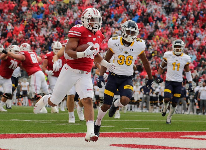 Wisconsin Badgers running back Jonathan Taylor (23) scores his second touchdown of the afternoon during the game against Kent State at Camp Randall Stadium in Madison.