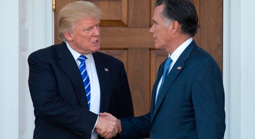 Then-President-elect Donald Trump shakes hands with Mitt Romney after their meeting at the clubhouse of Trump National Golf Club in Bedminster, New Jersey, Jan. 1, 2019.