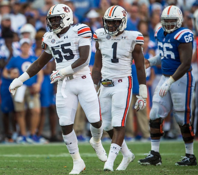 Auburn defesnive linemen T.D. Moultry (55) and Big Kat Bryant (1) celebrate after Moultry sacked Florida quarterback Kyle Trask (11) at Ben Hill Griffin Stadium in Gainesville, Fla., on Saturday, Oct. 5, 2019. Florida defeated Auburn 24-13.