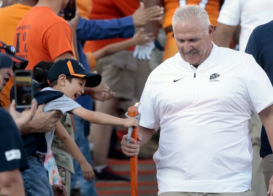 A young fan gets a handful of pick-axe as UTEP head coach Jim Senter makes his way to the field ahead of the Minersu2019 game against UTSA Saturday. 