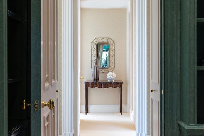 A mirror at the end of a hallway creates a visual focus.
