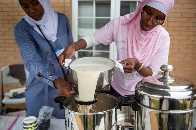 Marieme Diao of Newburgh, left, and Zahra Sulub of Newburgh strain traditional Somalian tea made from a blend of cardamom, cinnamon, and cloves to sell during the 18th Annual International Food Festival at the Islamic Society of Evansville, Sunday afternoon, Oct. 6, 2019.