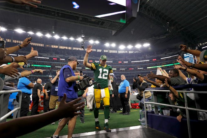 Green Bay Packers' Aaron Rodgers acknowledges fans as he walks off the field after the team's NFL football game against the Dallas Cowboys in Arlington, Texas, Sunday, Oct. 6, 2019.