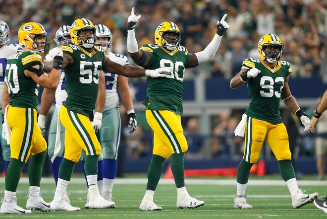 Oct 6, 2019; Arlington, TX, USA; Green Bay Packers outside linebacker Za'Darius Smith (55) and defensive tackle Montravius Adams (90) and middle linebacker B.J. Goodson (93) react to a missed field goal in the second quarter by the Dallas Cowboys  at AT&T Stadium.